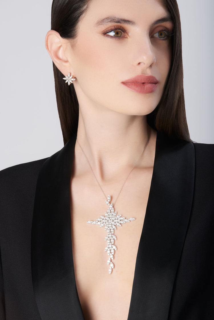 Necklace and earrings in 18k white gold with diamonds on model in a black jacket