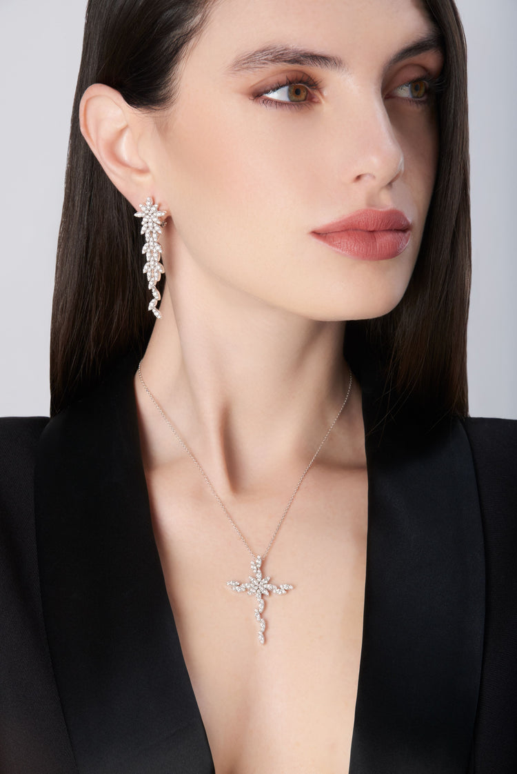 Pendant earrings and necklace with diamonds in 18k white gold worn by model in black jacket