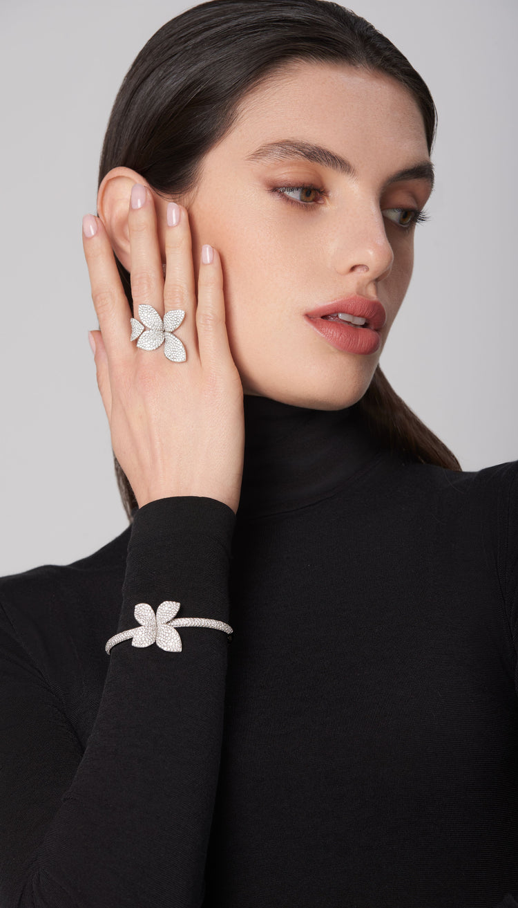 Ring and bracelet in 18k white gold with diamonds on model in black turtleneck