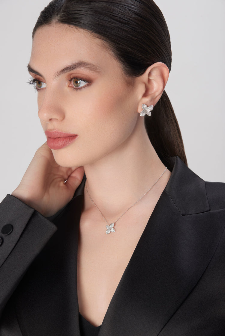 Earrings and necklace in 18k white gold with diamonds on model in black jacket
