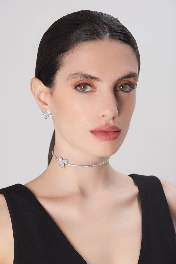 Choker and earrings in 18k white gold with diamonds on model in black dress