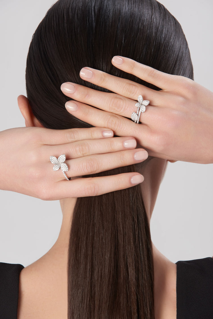 Rings in 18k white gold with diamonds on model with hair pulled back