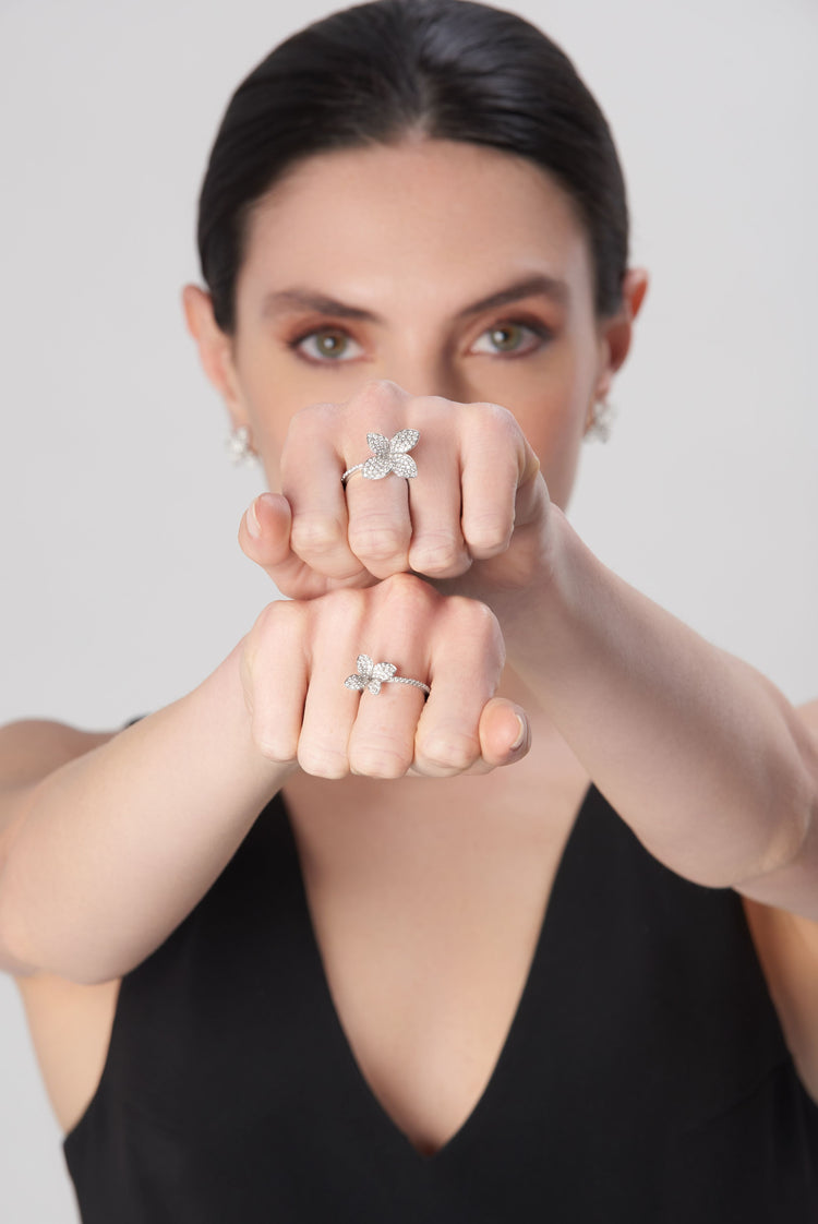 Rings on model's fingers in 18k white gold with diamonds, black dress