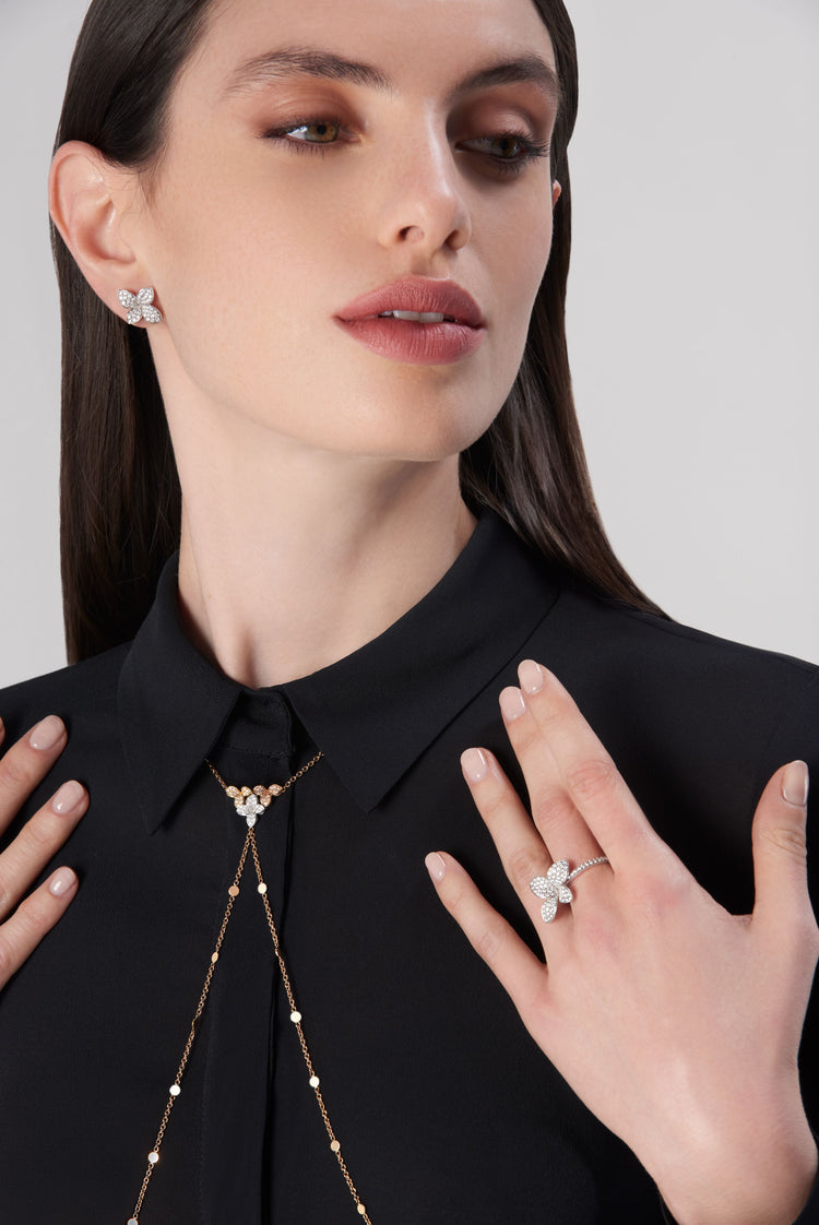 Earrings, ring and body chain in 18k yellow gold, rose and white gold with diamonds on model in black blouse