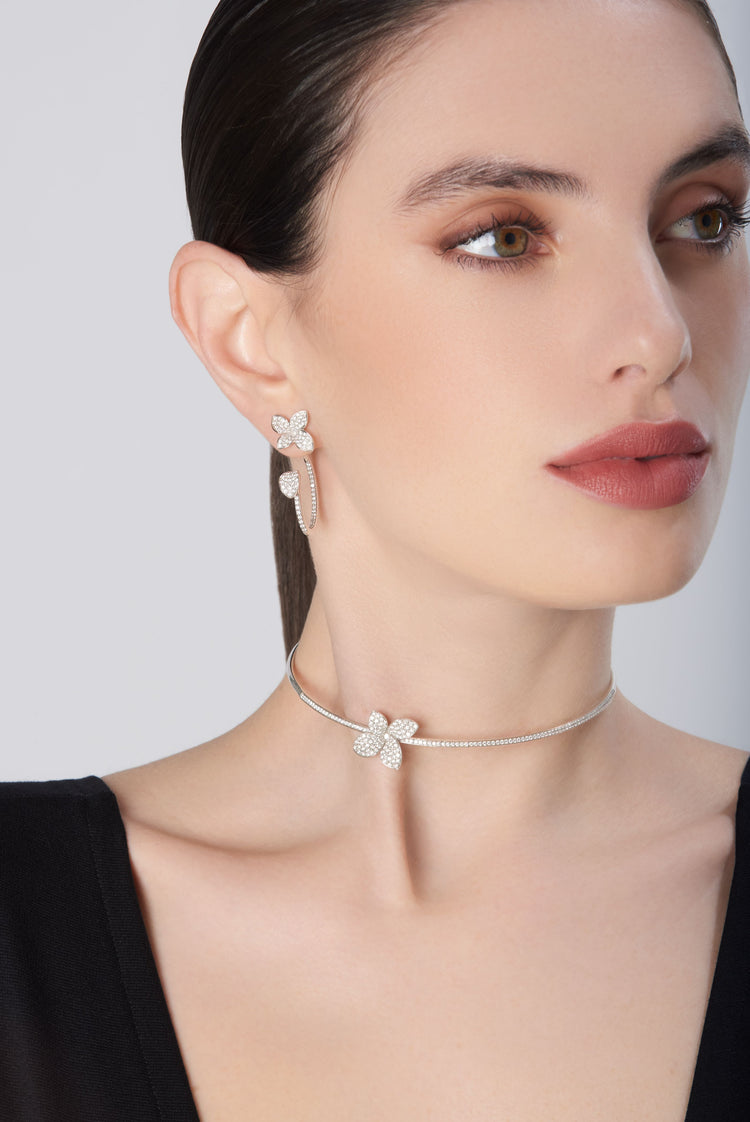 Choker and earrings with diamonds in 18k white gold worn by model in black dress