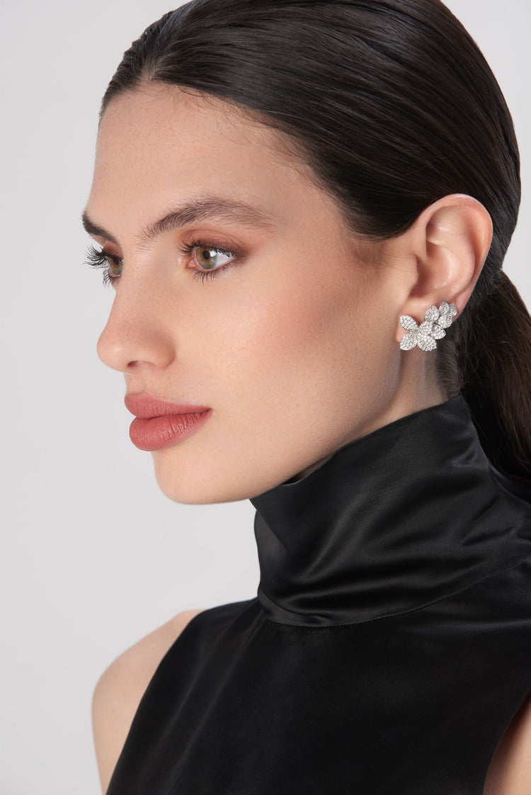 Earrings in 18k white gold with diamonds on model in satin high-neck dress