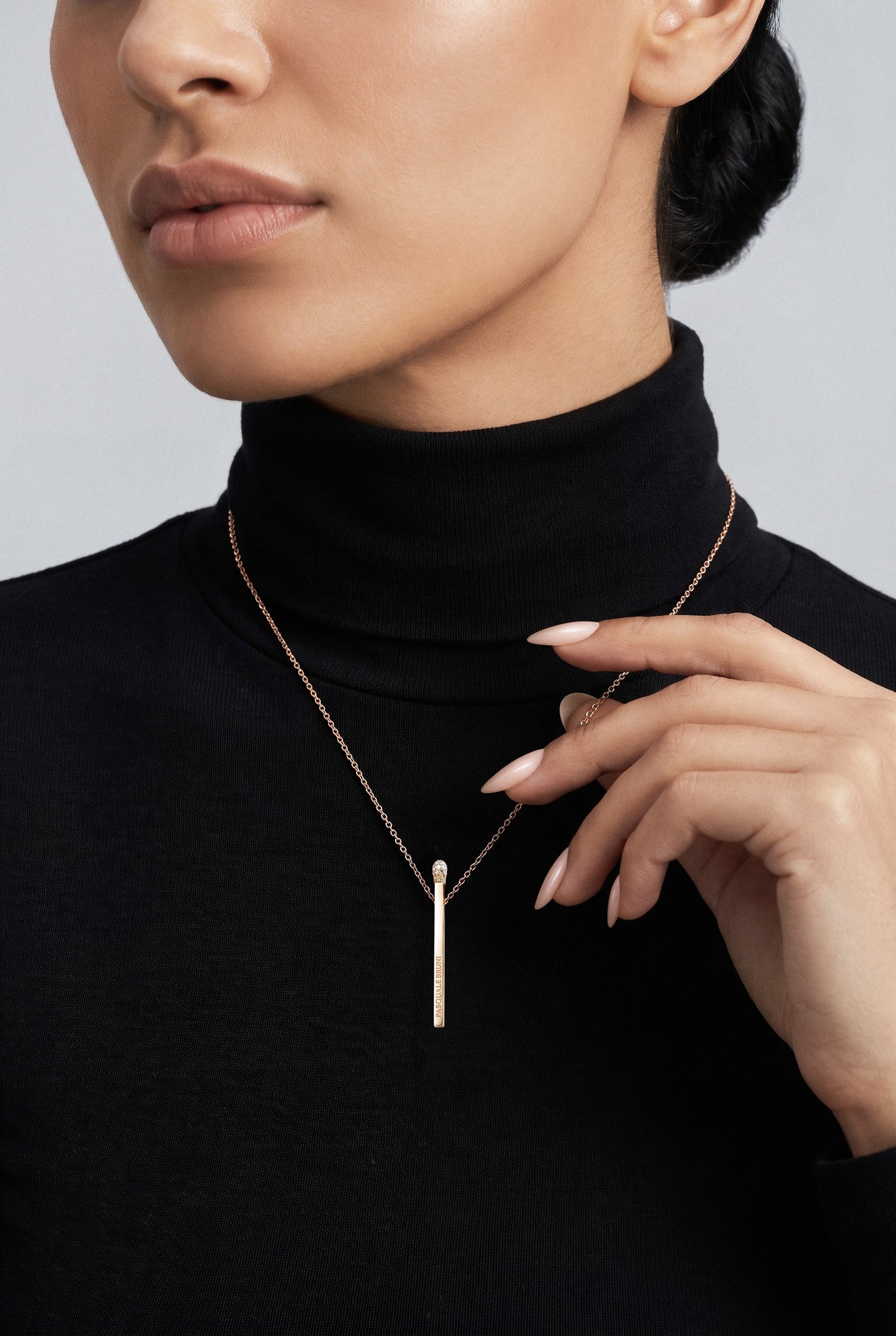 Model wearing a Necklace in 1k Rose Gold with White and Champagne diamonds with a black turtleneck