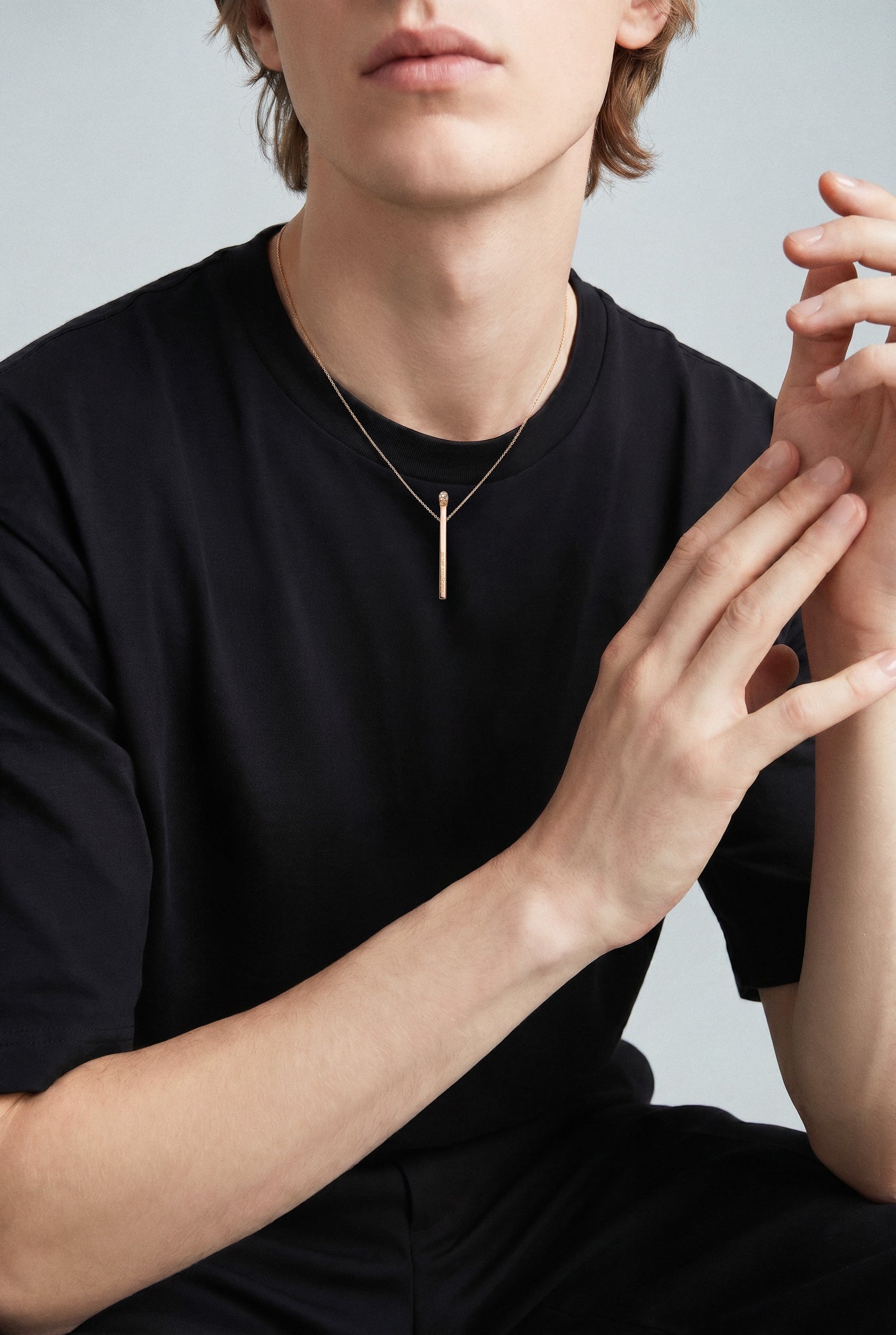 Model wearing a Necklace in 18k Rose Gold with White and Champagne diamonds with a black t.shirt