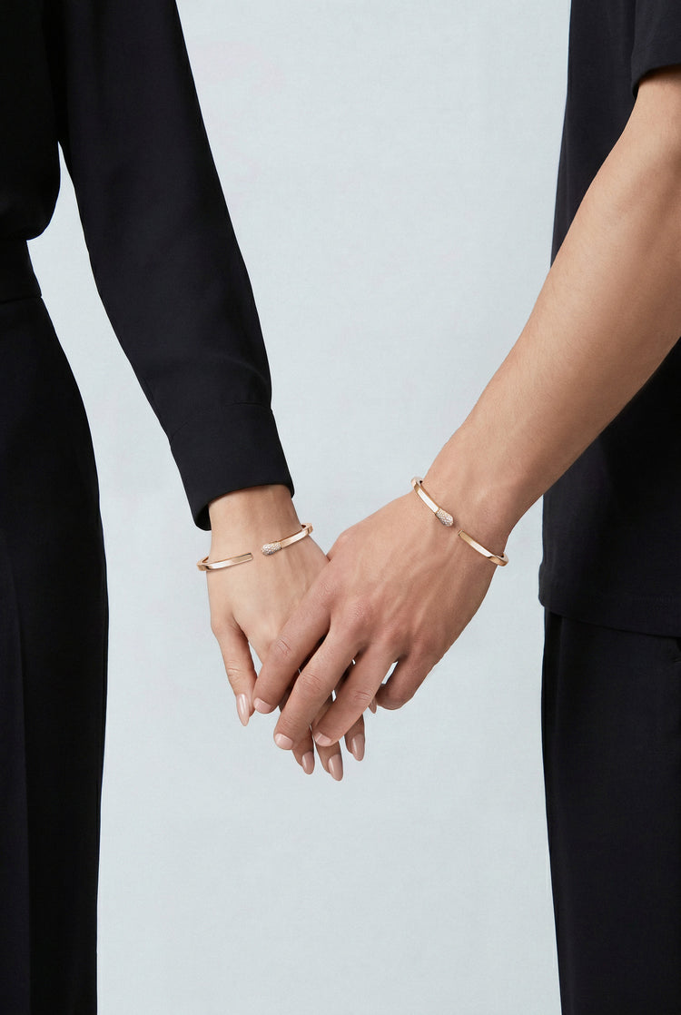 Couple wearing Bracelets in 18k Rose Gold with White and Champagne diamonds and black outfits