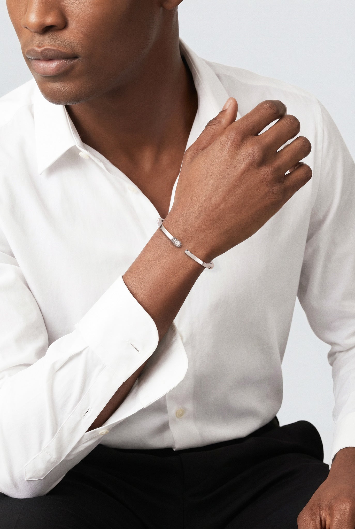 Model wearing a Bracelet in 18k White Gold with Diamonds and a white shirt