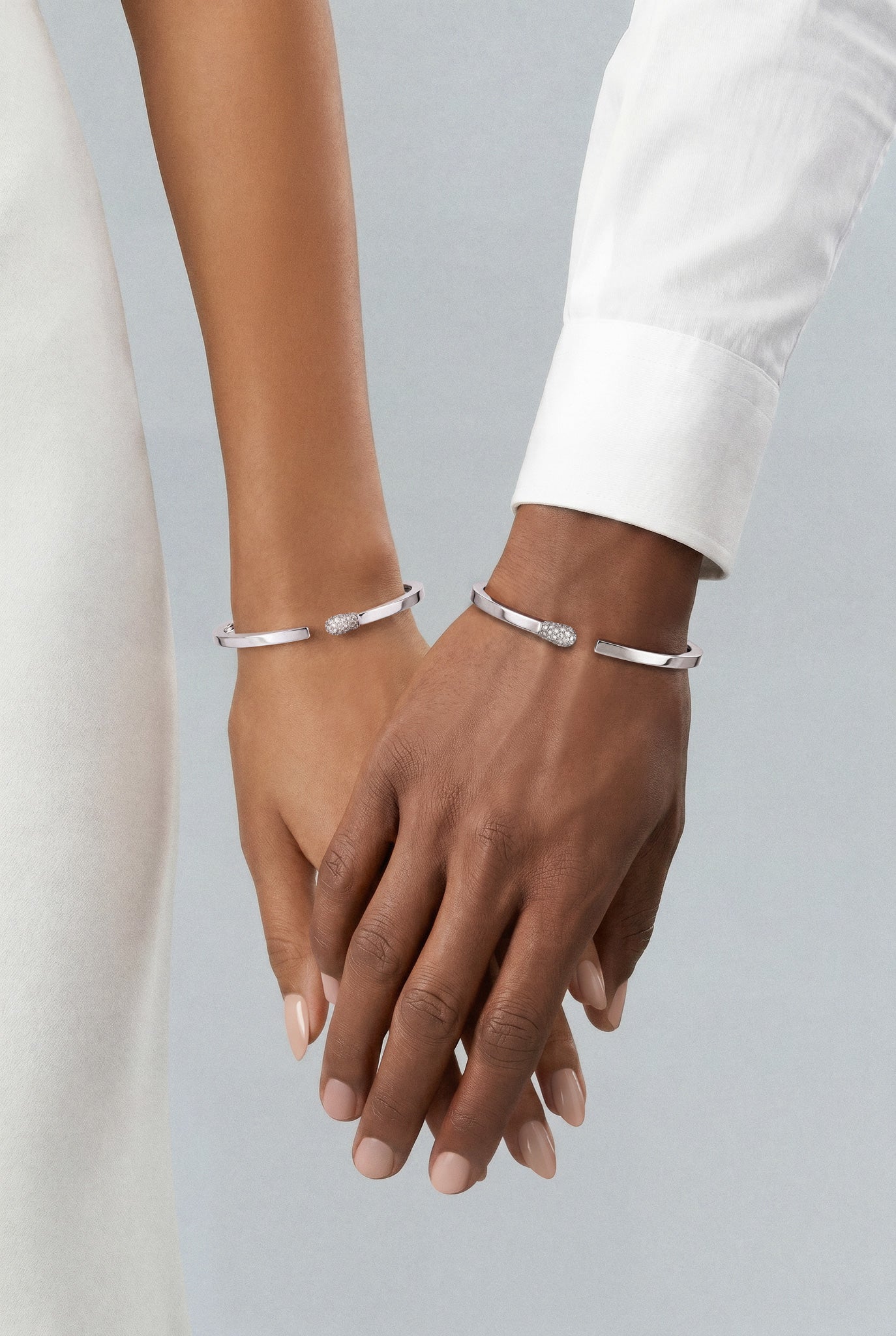 Models wearing Bracelets in 18k White Gold with Diamonds and white outfits