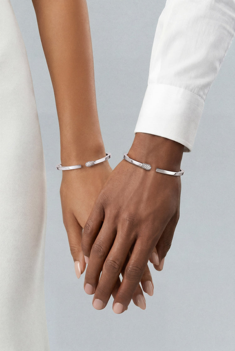 Models wearing Bracelets in 18k White Gold with Diamonds and white outfits