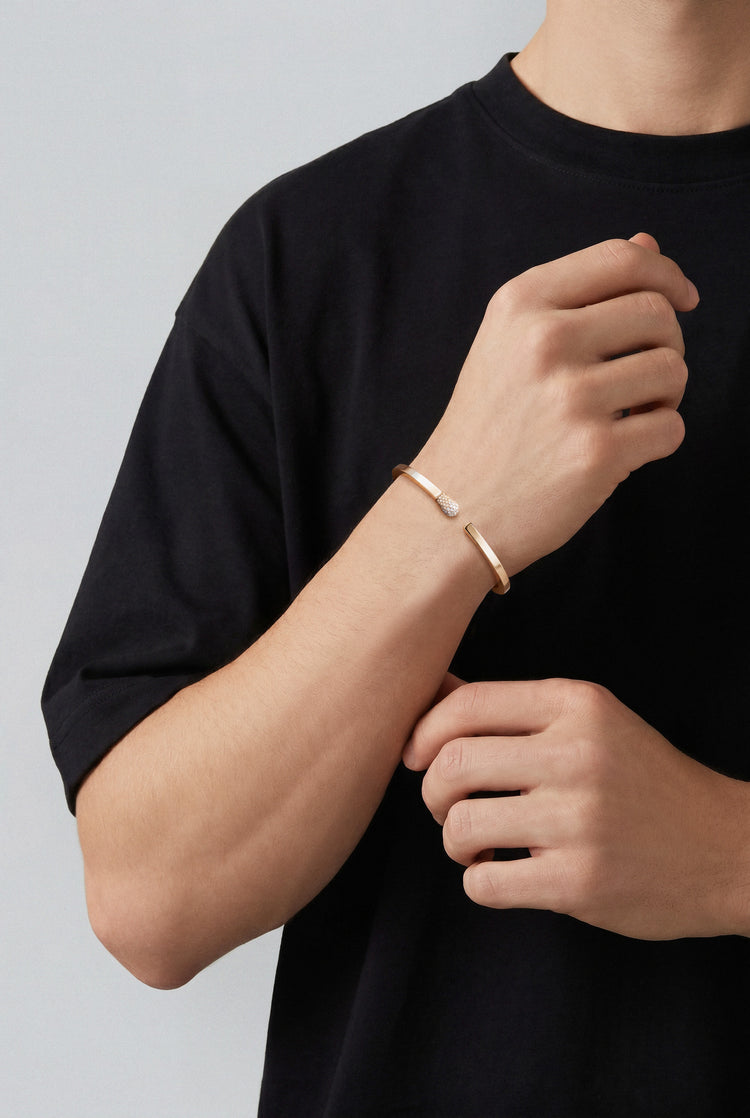 Model wearing a Bracelet in 18k Rose Gold with White and Champagne diamonds and a black tshirt