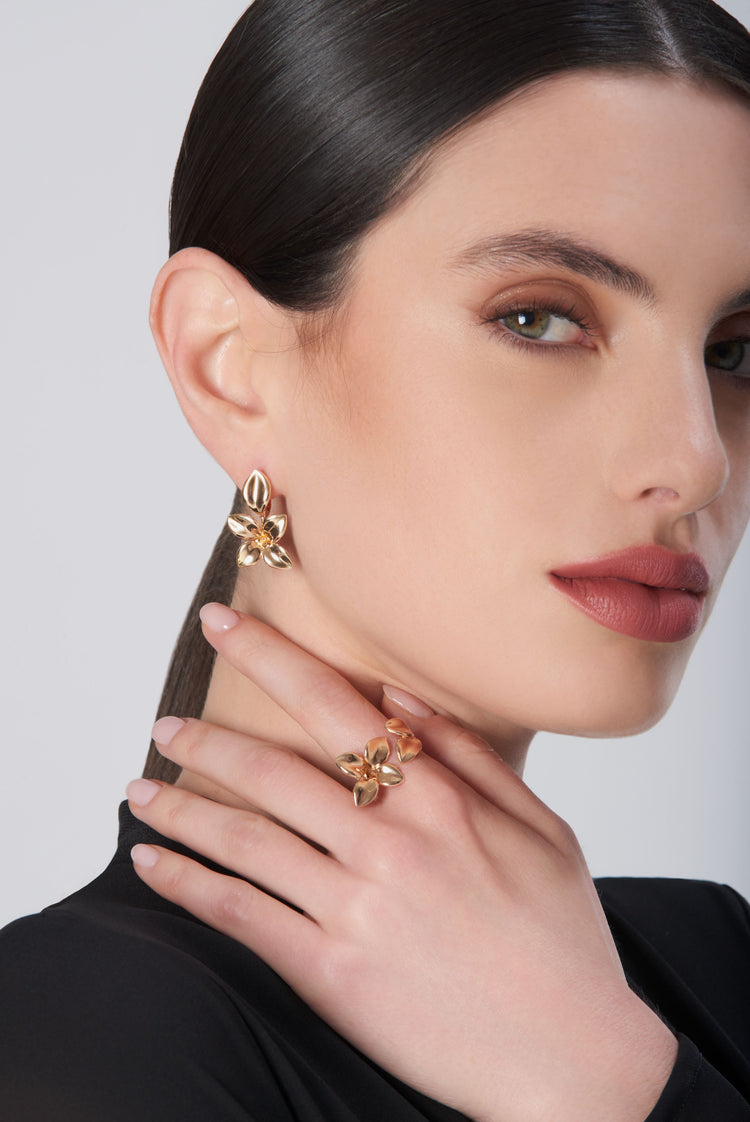 Earrings and ring in 18k rose gold on model in black blouse