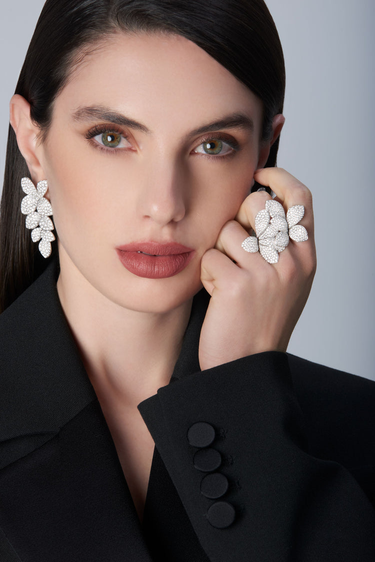 Woman wearing a black jacket and Ring and earrings in 18k White Gold with White Diamonds.