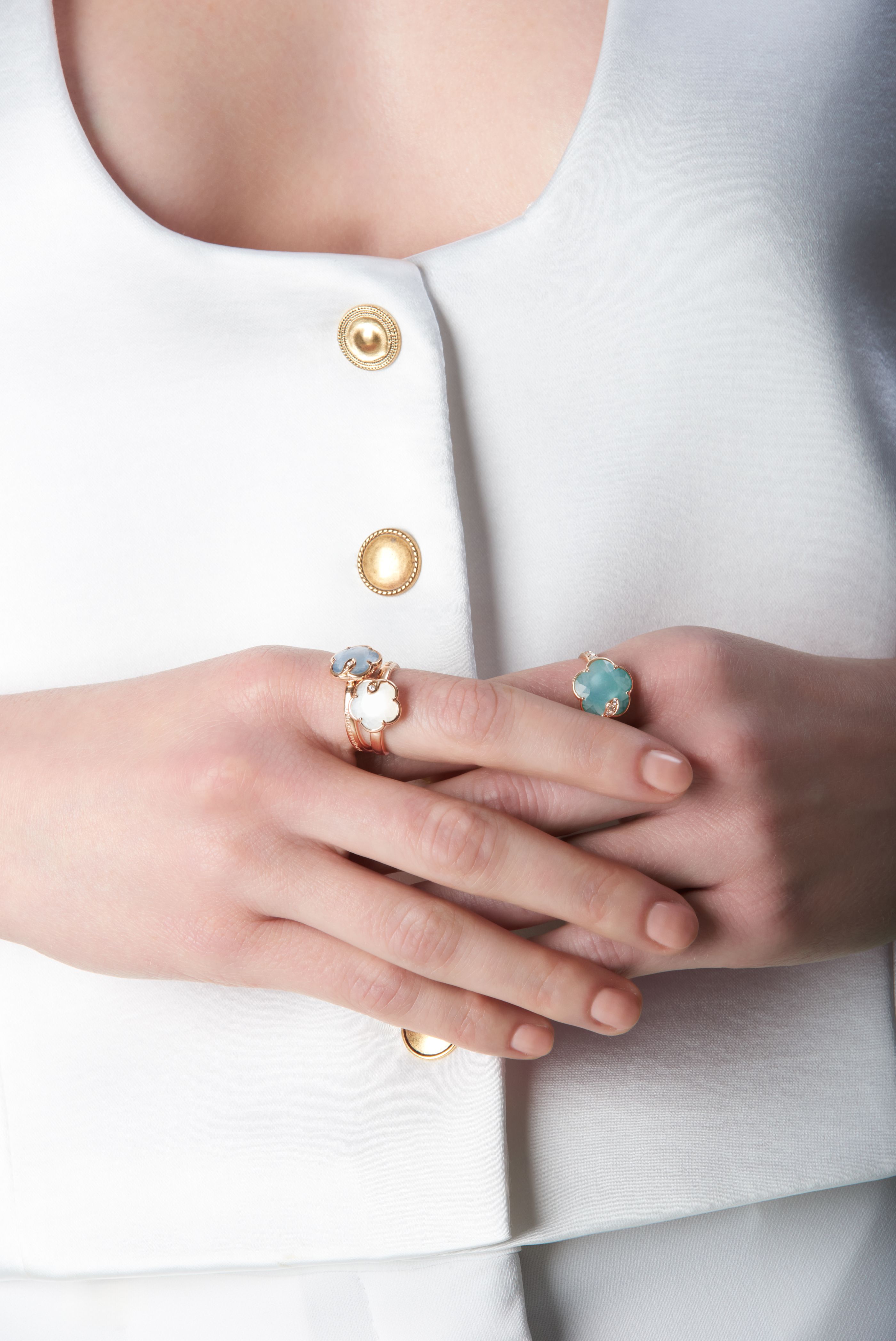 Combination of rings with coloured gems on model.