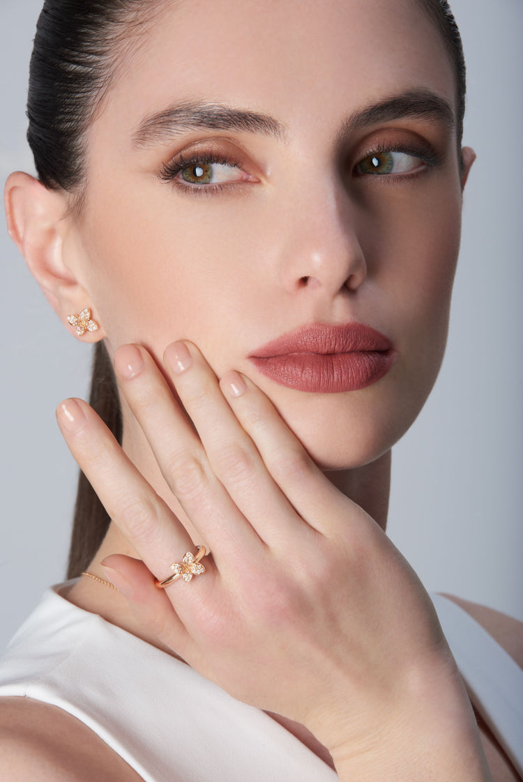 Ring and earrings in 18k Rose Gold with Diamonds on model wearing a white top