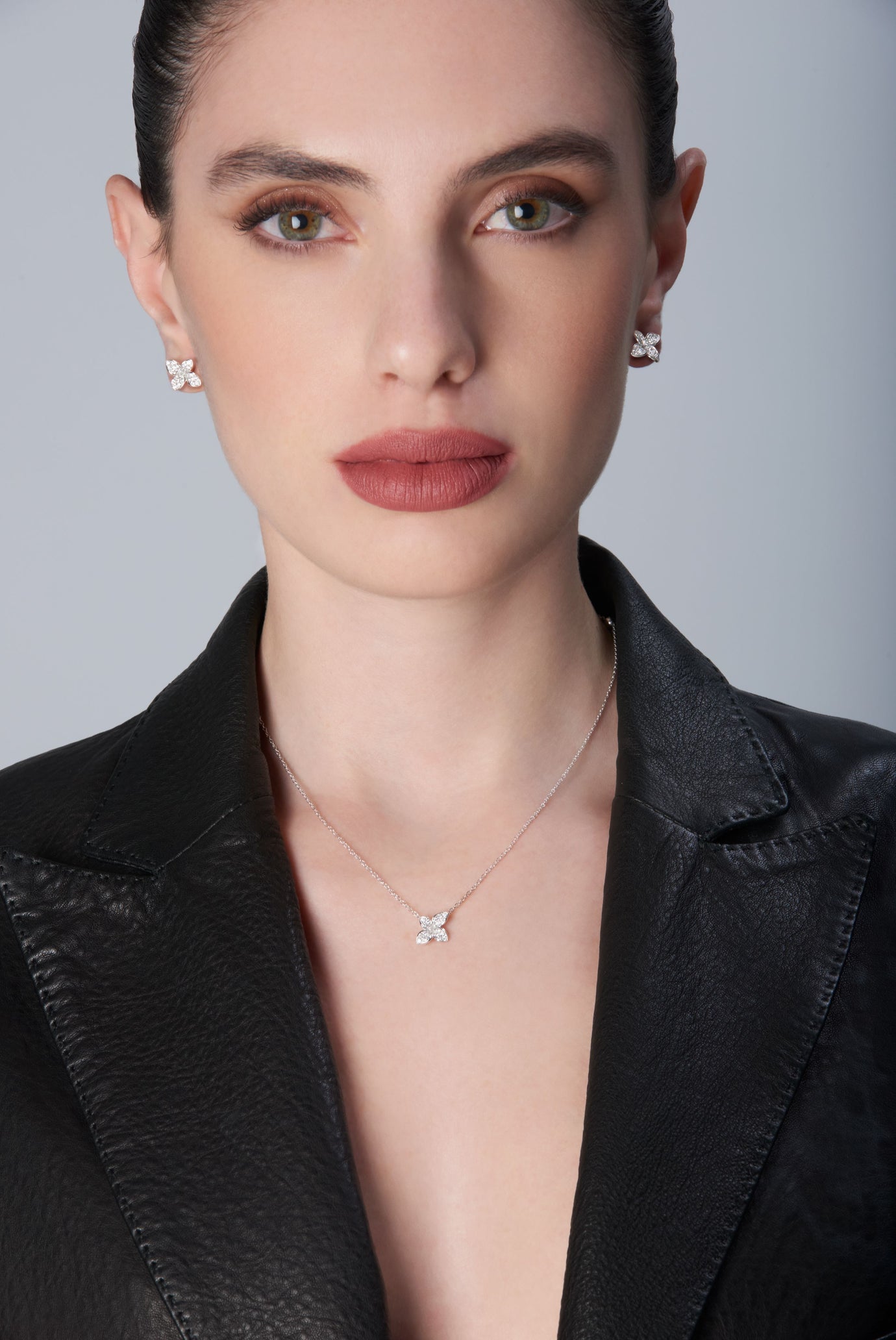 Necklace and earrings in 18k White Gold with White Diamonds on model wearing a black leather jacket