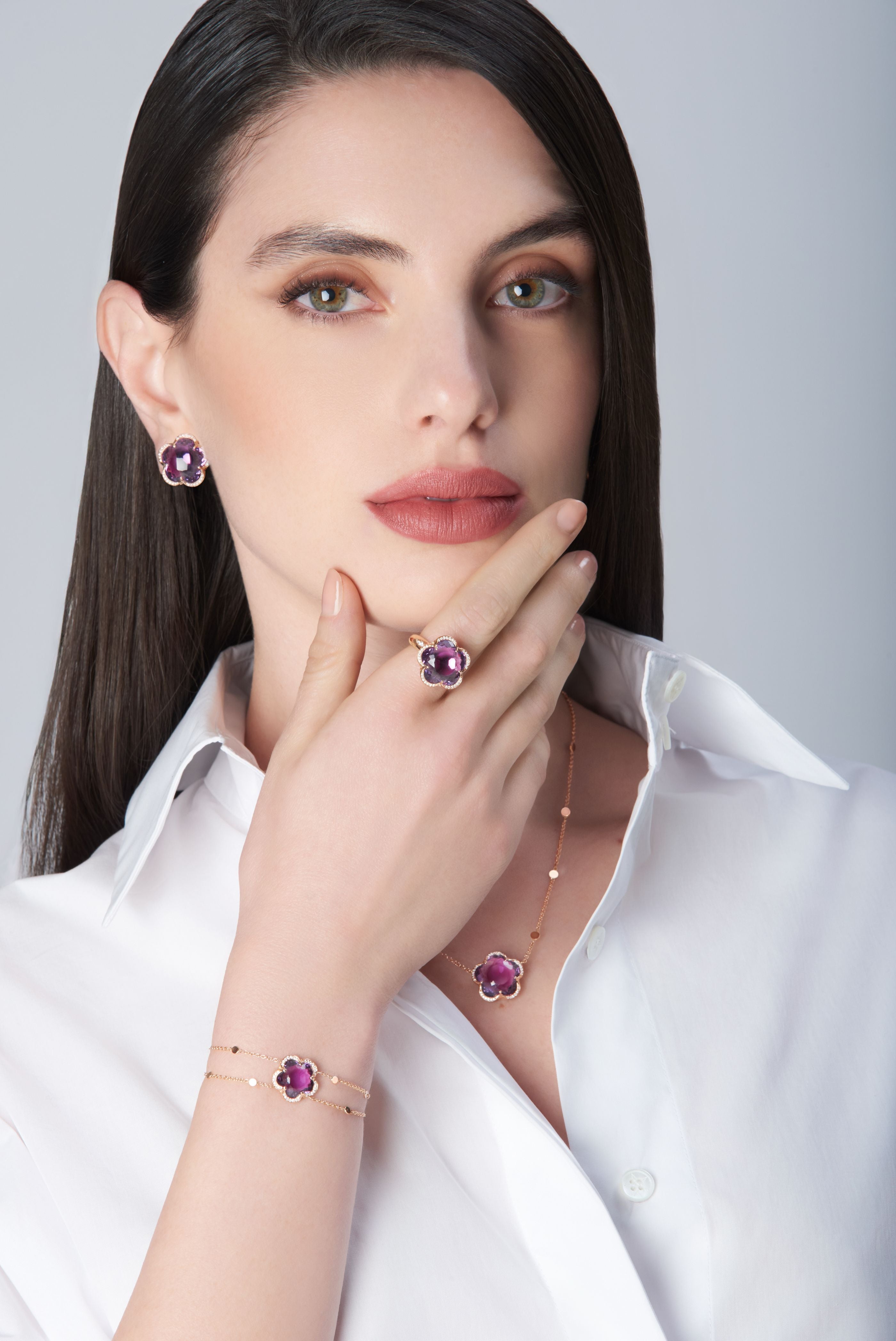 Combination of earrings, ring, necklace and bracelet in 18k Rose Gold with Amethyst and Diamonds on model with white shirt