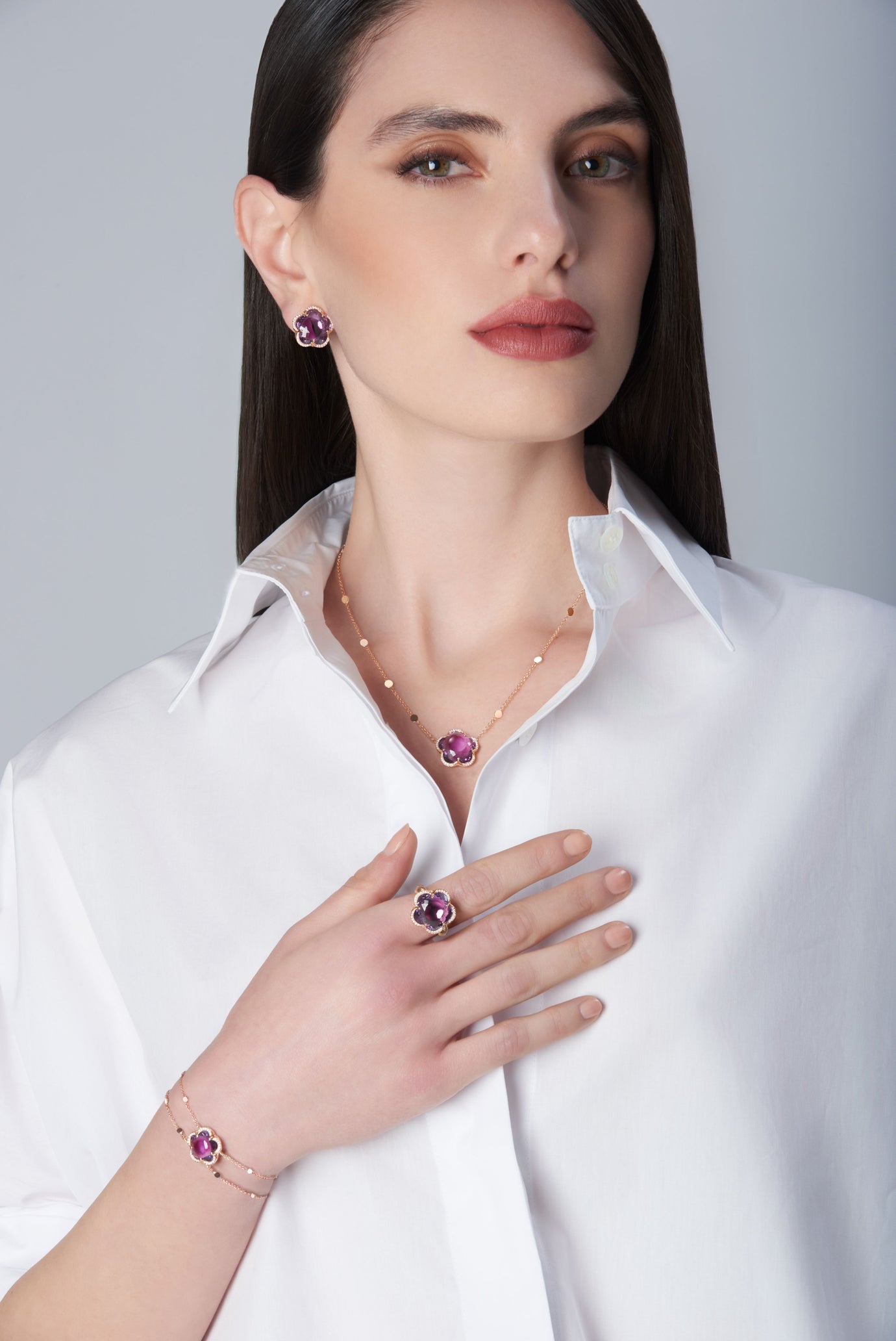 Earring, necklace, ring and bracelet in 18k Rose Gold with Amethyst and diamonds on model with white shirt