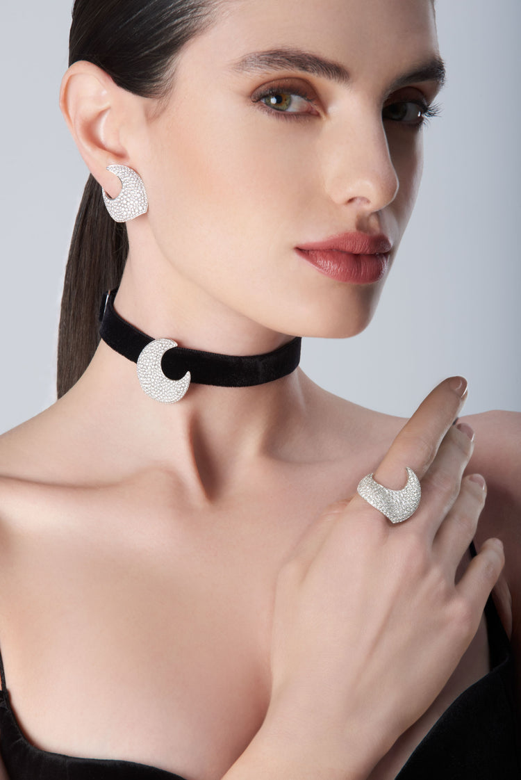 Woman wearing diamond earrings, ring and black velvet choker in 18k White Gold with white diamonds