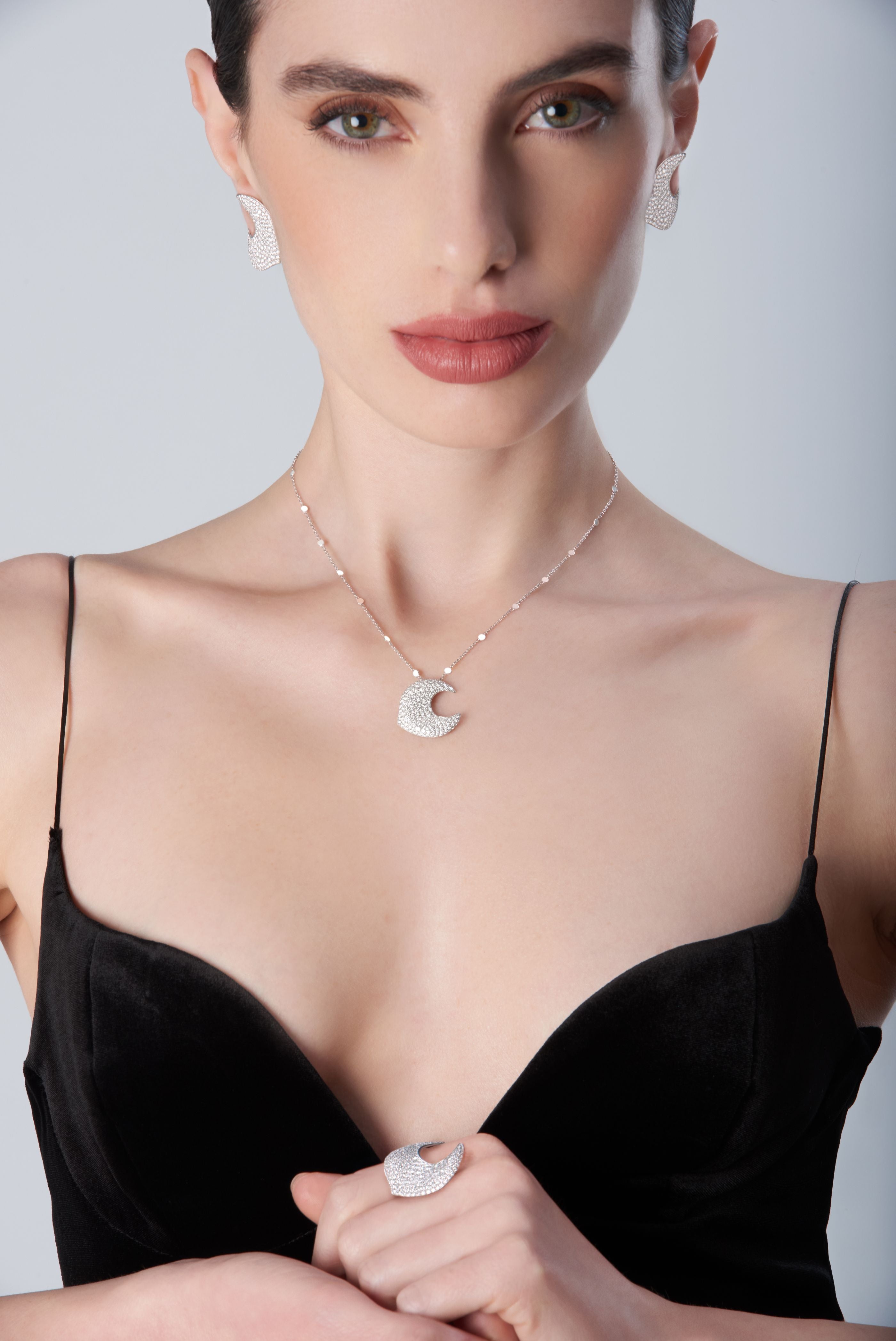 Woman wearing a black choker and earrings18k White Gold with White Diamonds, Small Size.