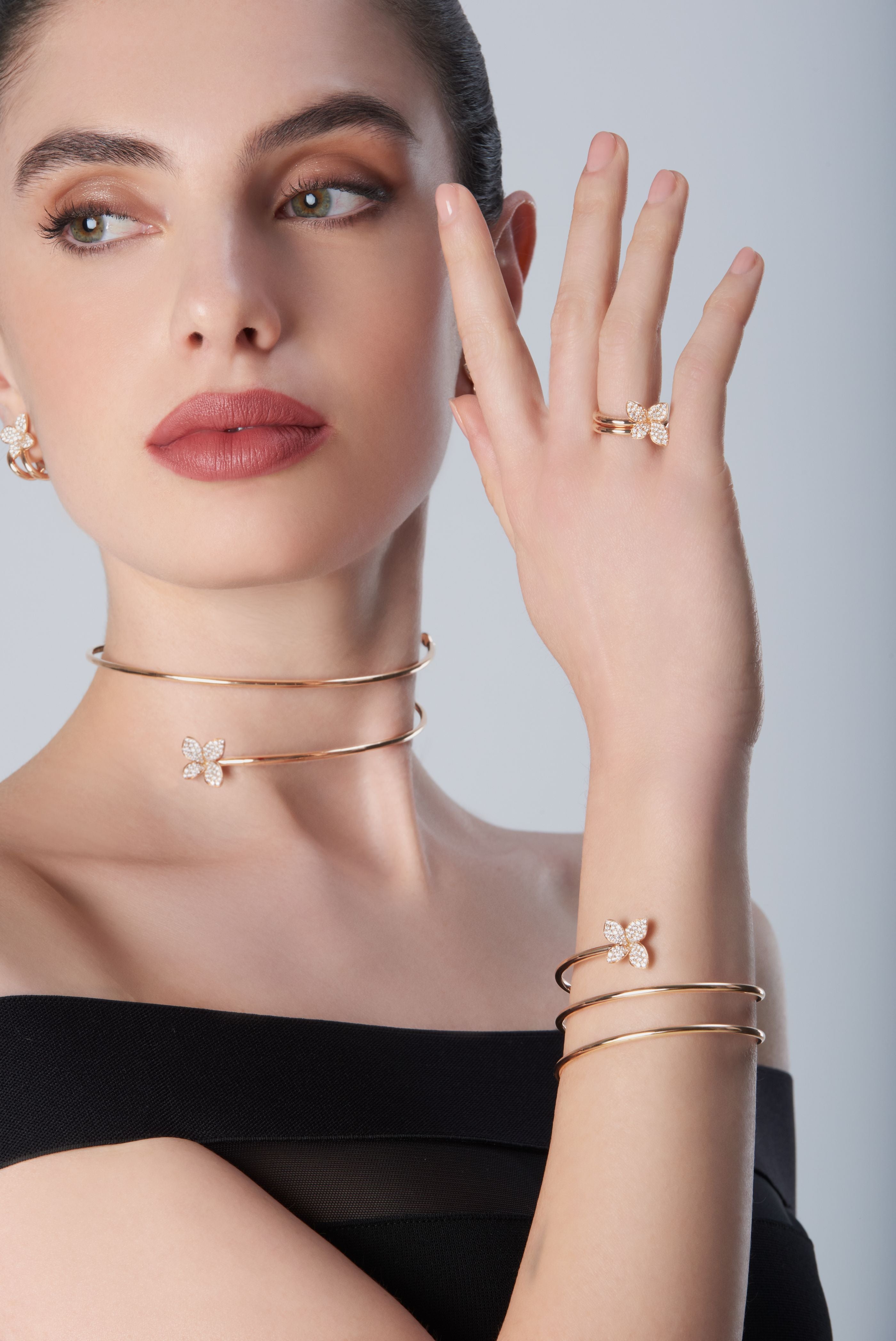 Combination of ring, bracelet, choker in 18k Rose Gold with Diamonds on model wearing a black dress