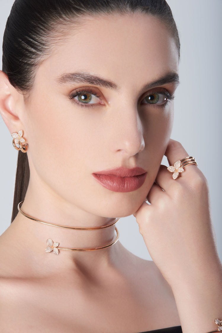 Combination of earrings, ring and choker in 18k Rose Gold with Diamonds on model with black dress