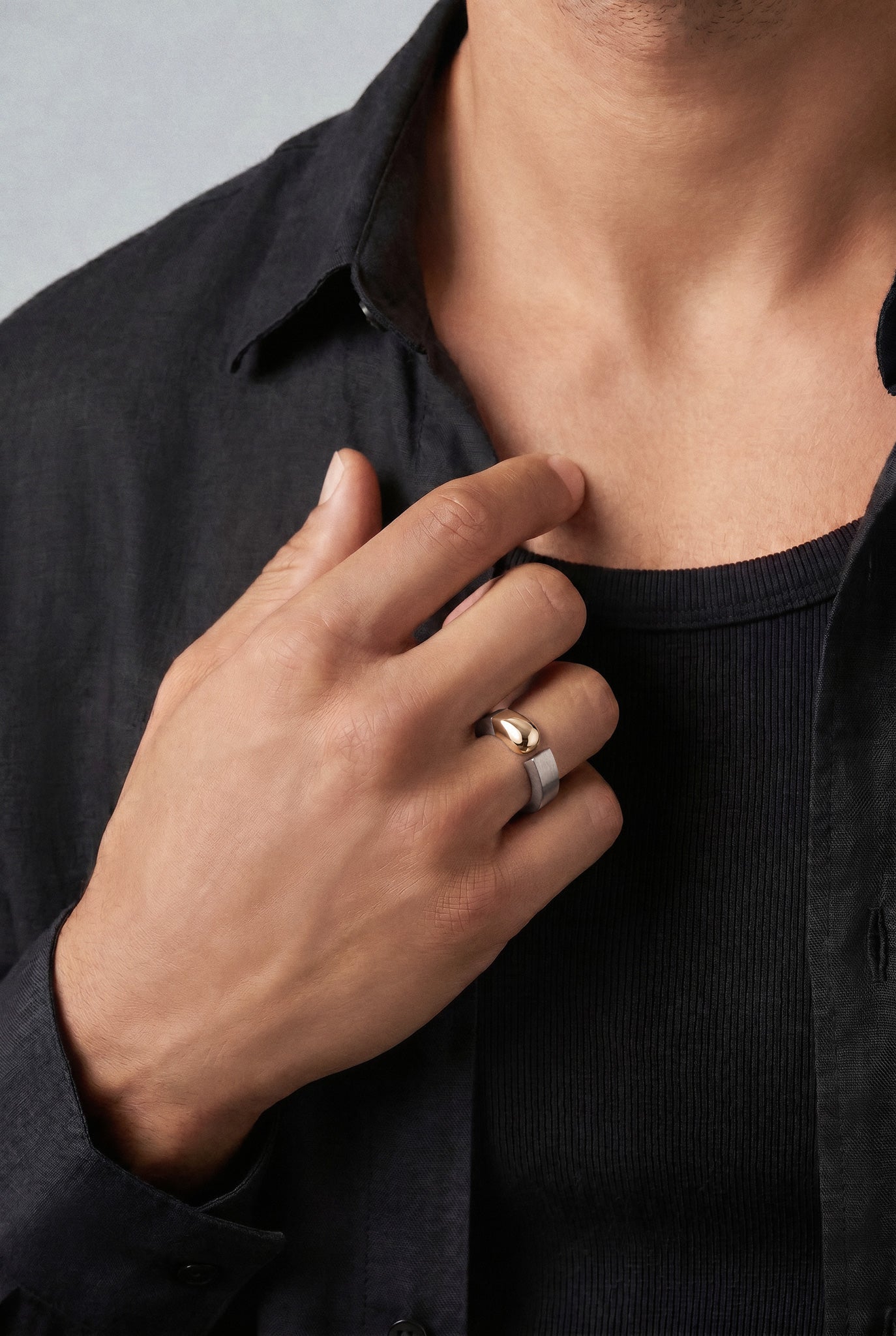 Model wearing a 18k rose gold and grey titanium and a black shirt