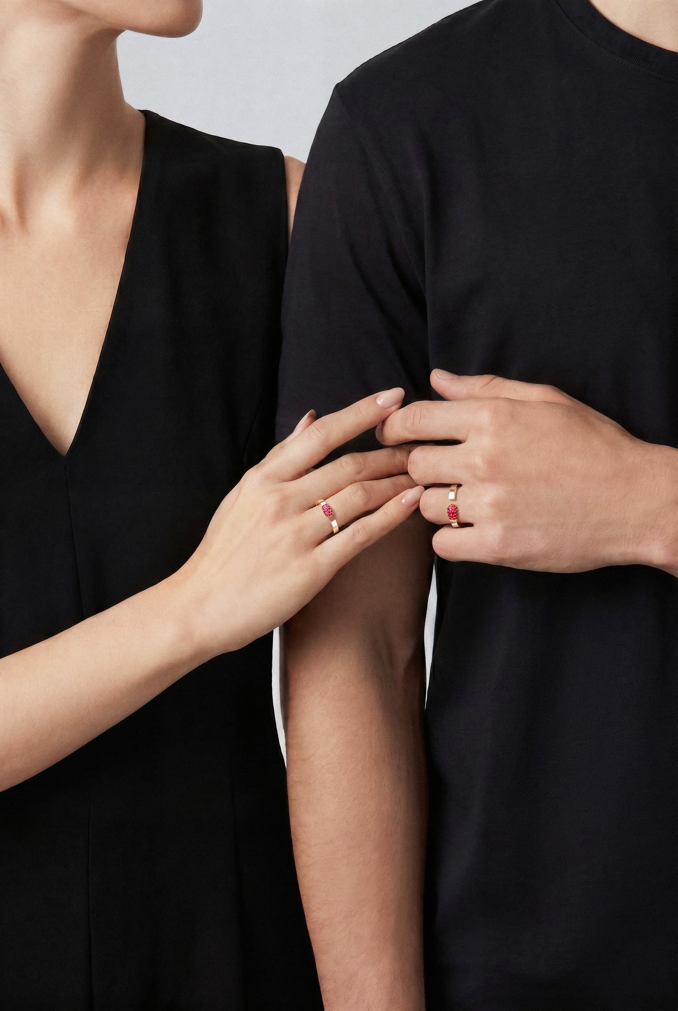 Models wearing a Ring in 18k Rose Gold with Rubies and black outfits