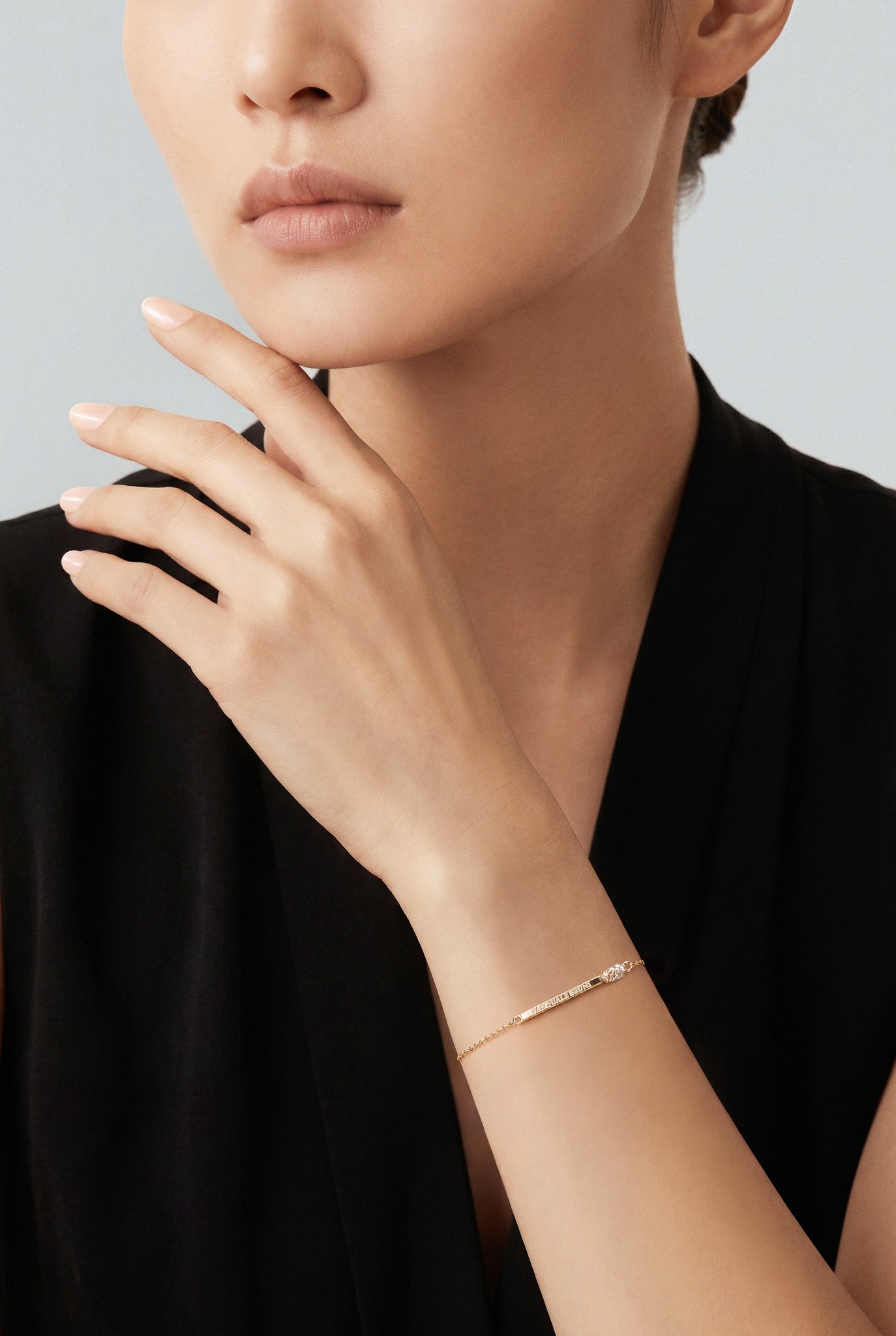 Model wearing a black V neck top and a Bracelet in 18k Rose gold with white and champagne diamonds