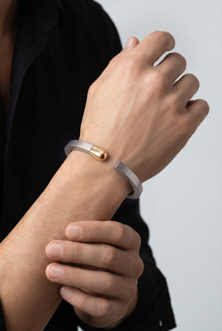 Model wearing a black shirt and a Bracelet in 18k Rose Gold and grey titanium