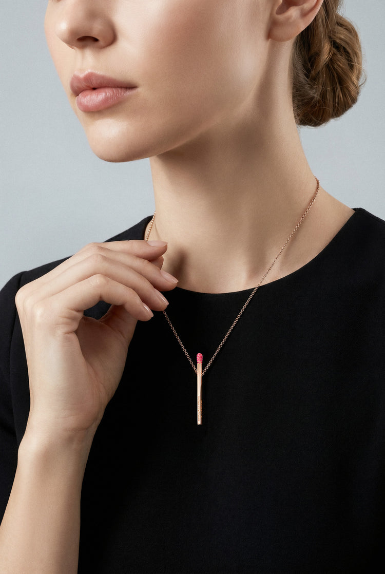 Model wearing a black top and Necklace in 18k Rose gold with Rubies