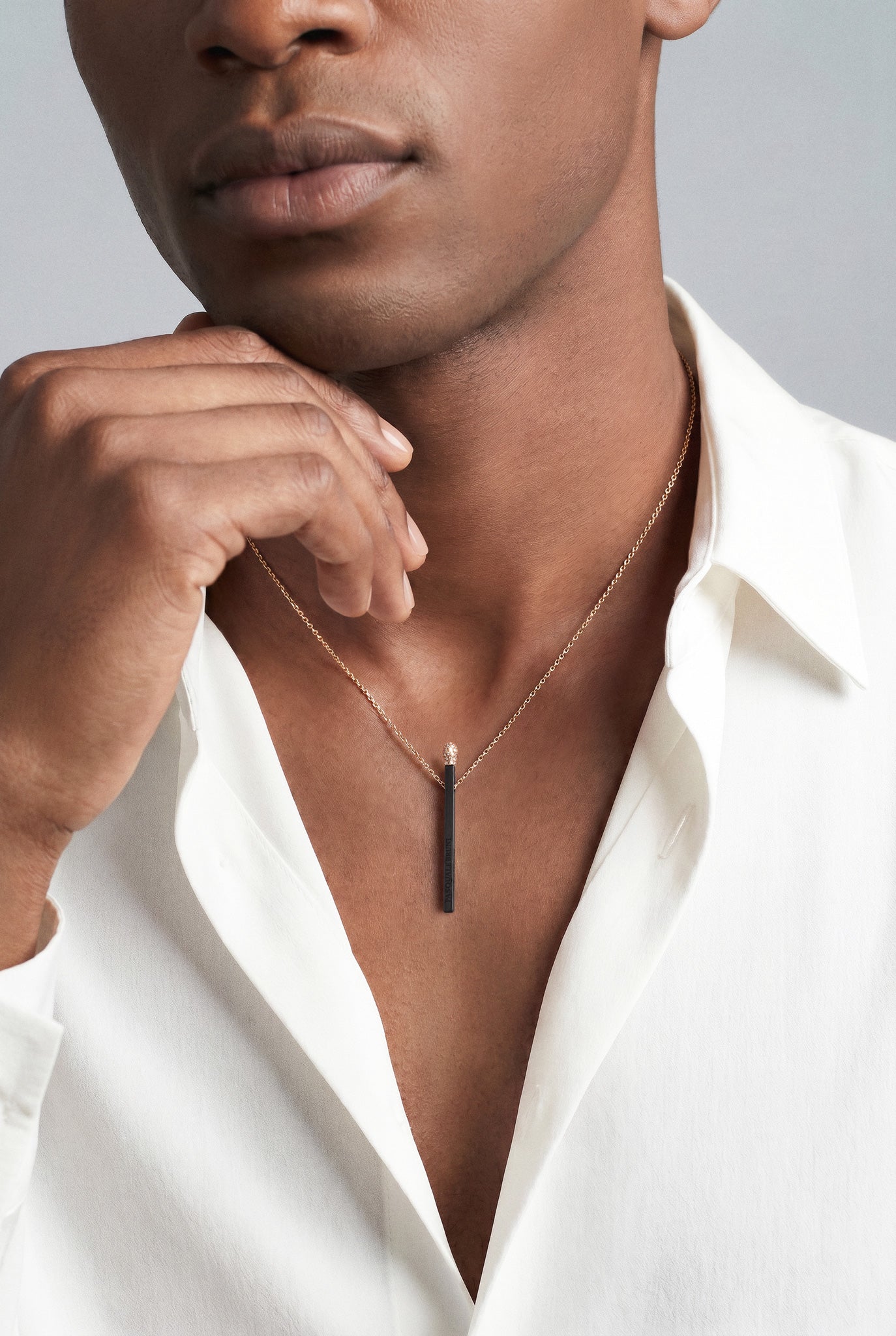 Model wearing a white shirt and Necklace in 18k Rose Gold and Black titanium with white and champagne diamonds