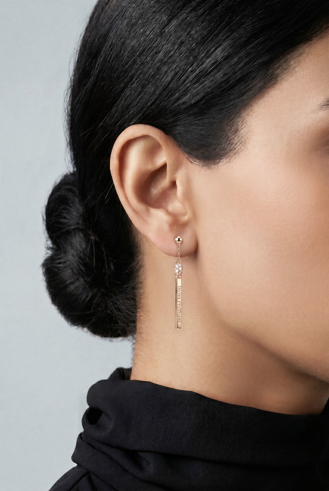 Model wearing a black high neck top and Earrings in 18k White gold with white and champagne diamonds