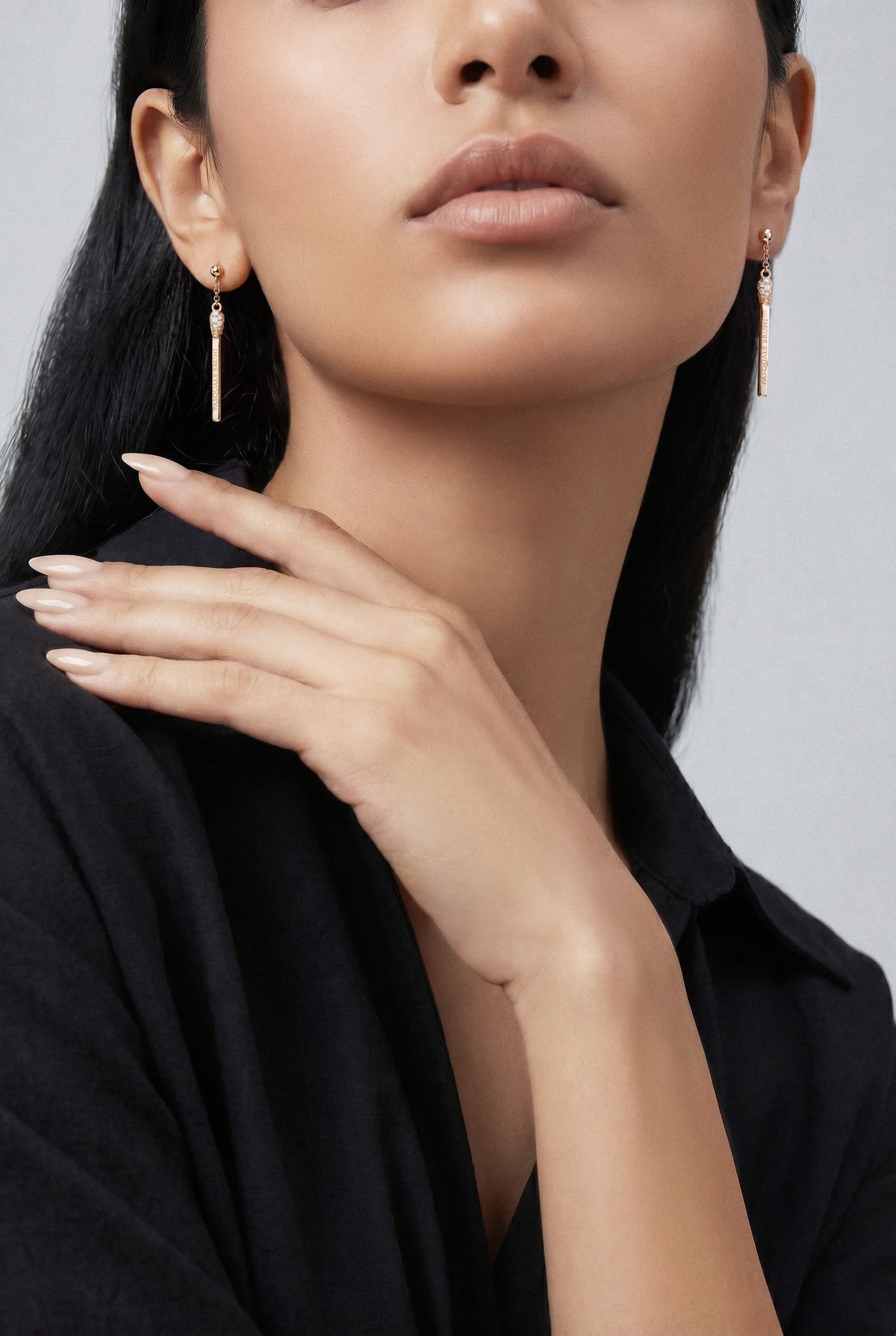 Model wearing a black shirt and Earrings in 18k White gold with white and champagne diamonds