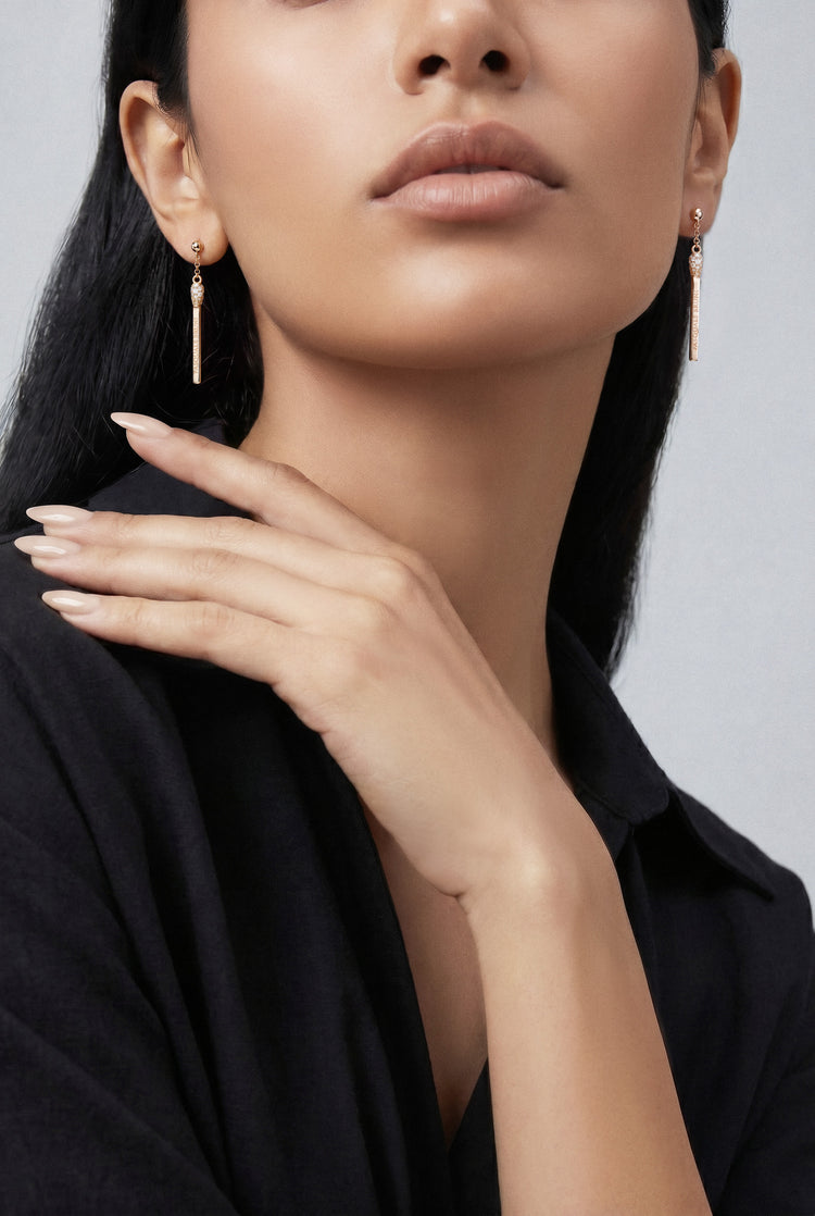 Model wearing a black shirt and Earrings in 18k White gold with white and champagne diamonds