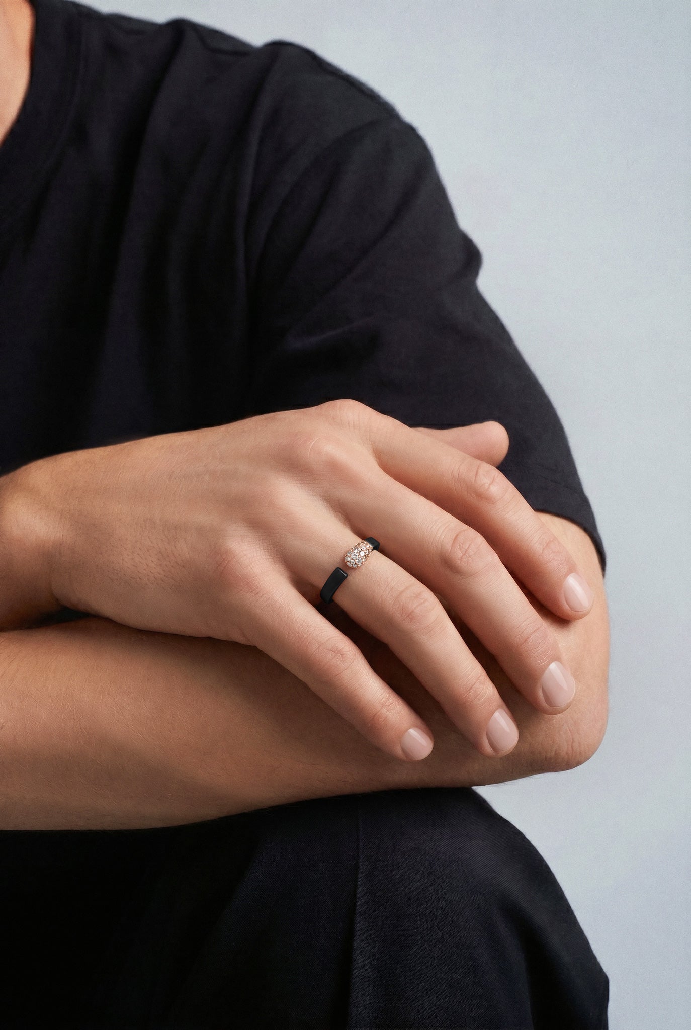 Model wearing a Ring in 18k Rose Gold and Black Titanium with White and Champagne Diamonds with a black tshirt