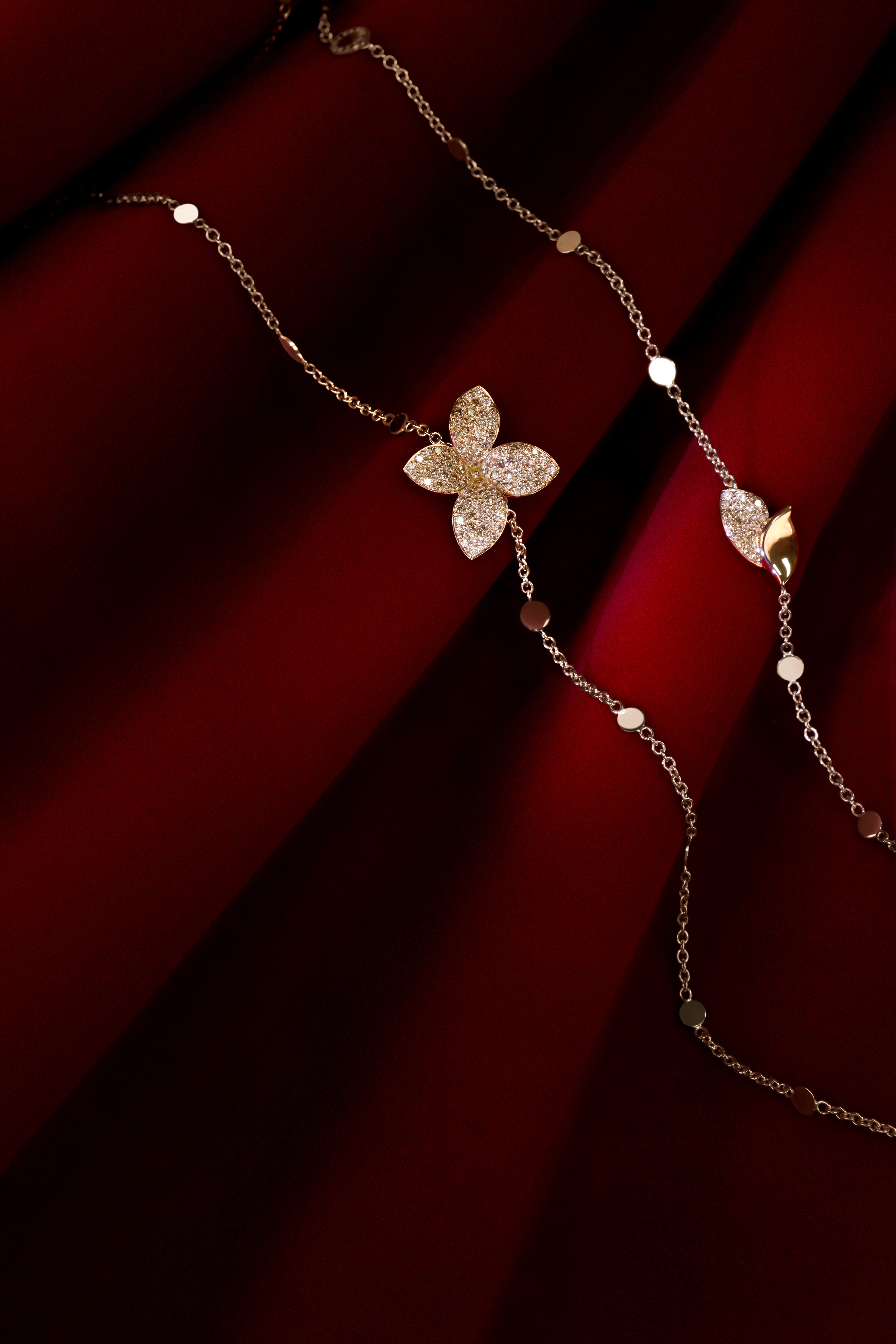 Necklace in 18k Rose Gold with Diamonds on red background.