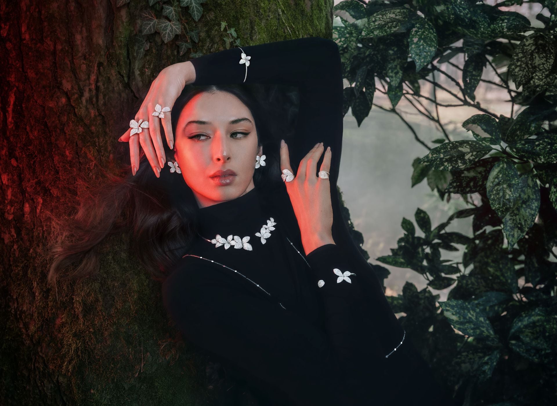 Model wearing a black turtleneck with the Giardini Segreti collection: rings, bracelet, collier and earrings in 18k White Gold with White Diamonds.