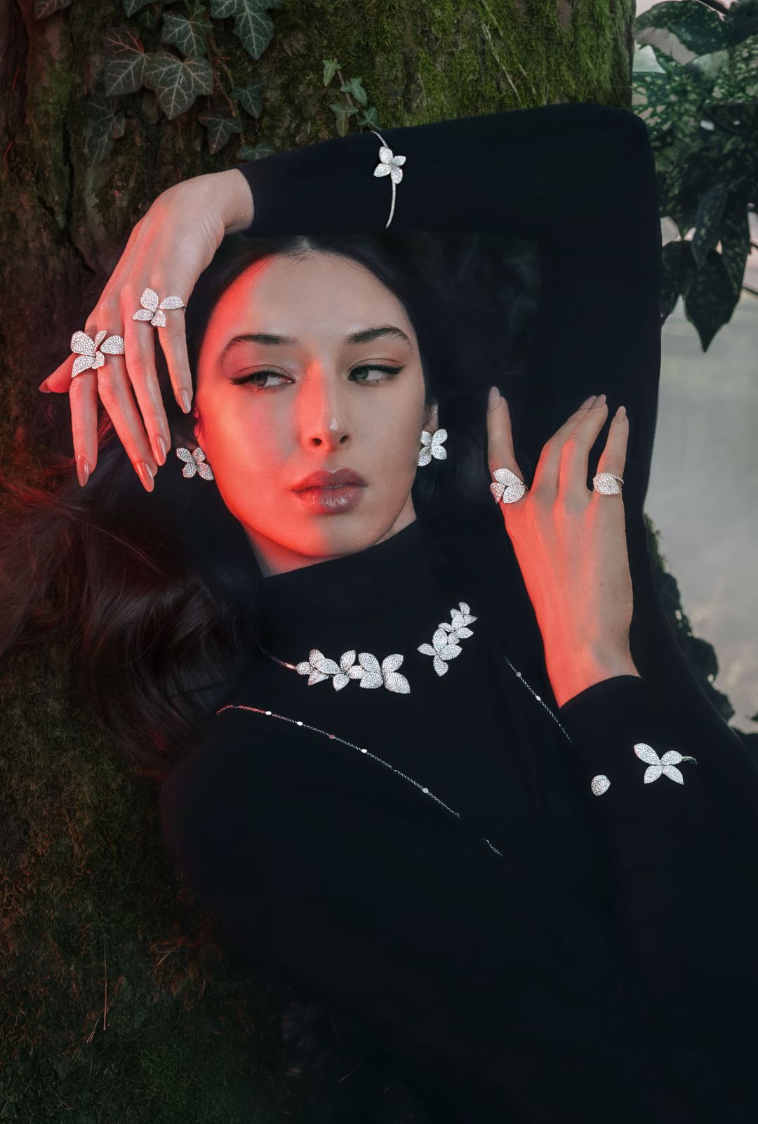 Model wearing a black turtleneck with the Giardini Segreti collection: rings, bracelet, collier and earrings in 18k White Gold with White Diamonds.