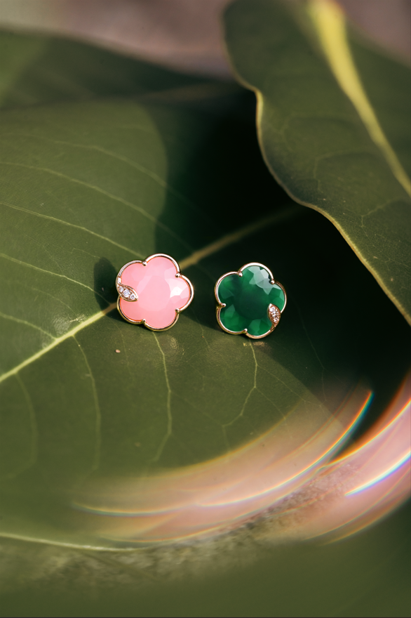 Colored Petit Joli earrings on green leaves